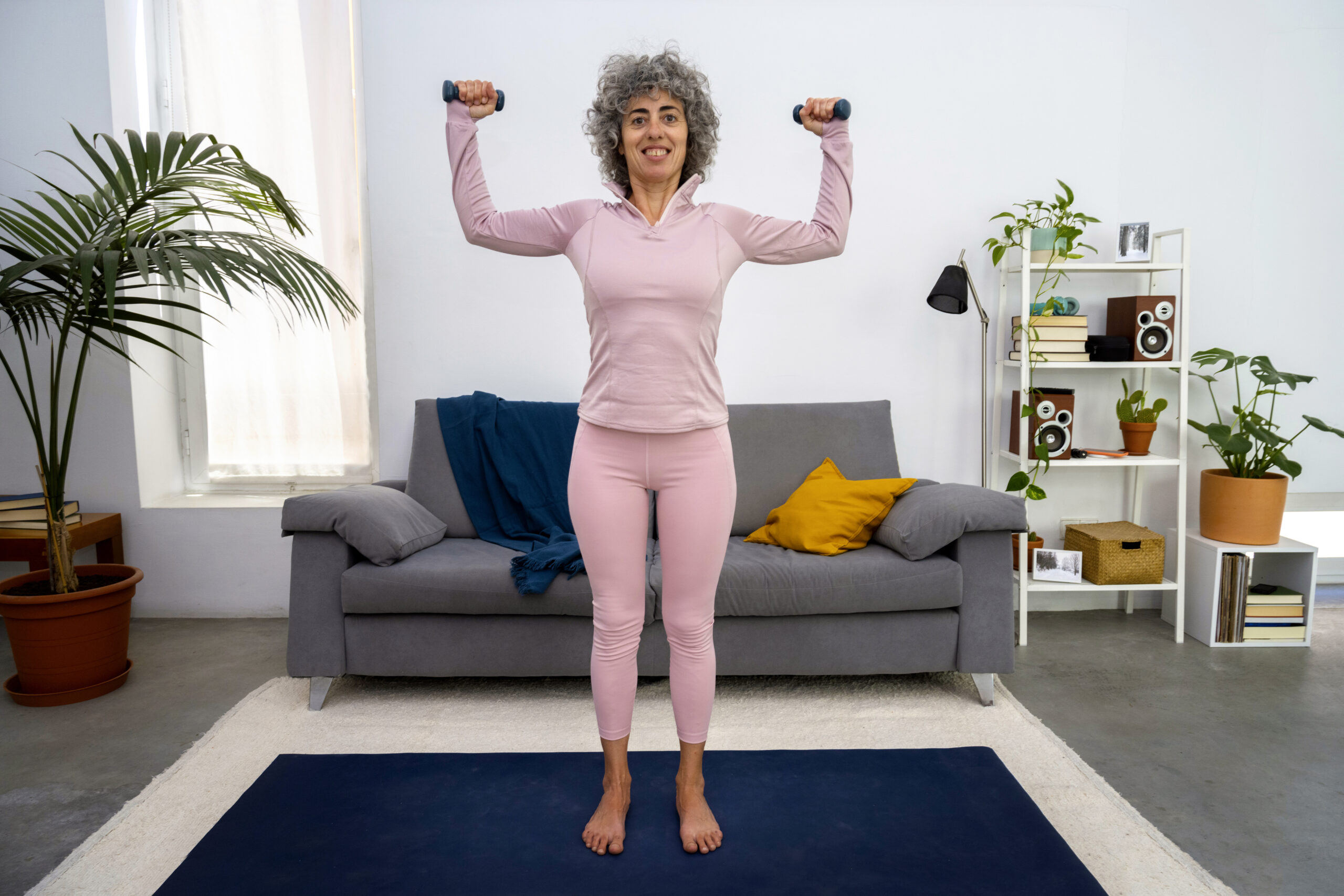 front view woman exercising with dumbbells scaled