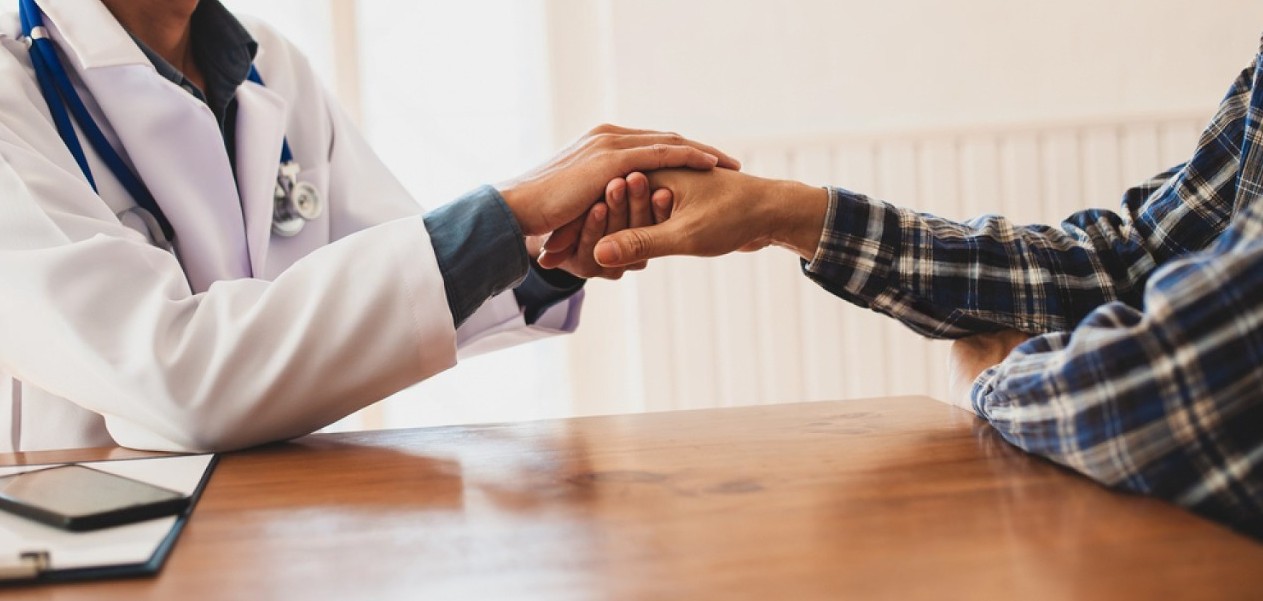 stock photo doctors hold hands to comfort and encourage cancer patients the concept of psychiatric treatment 1828085357